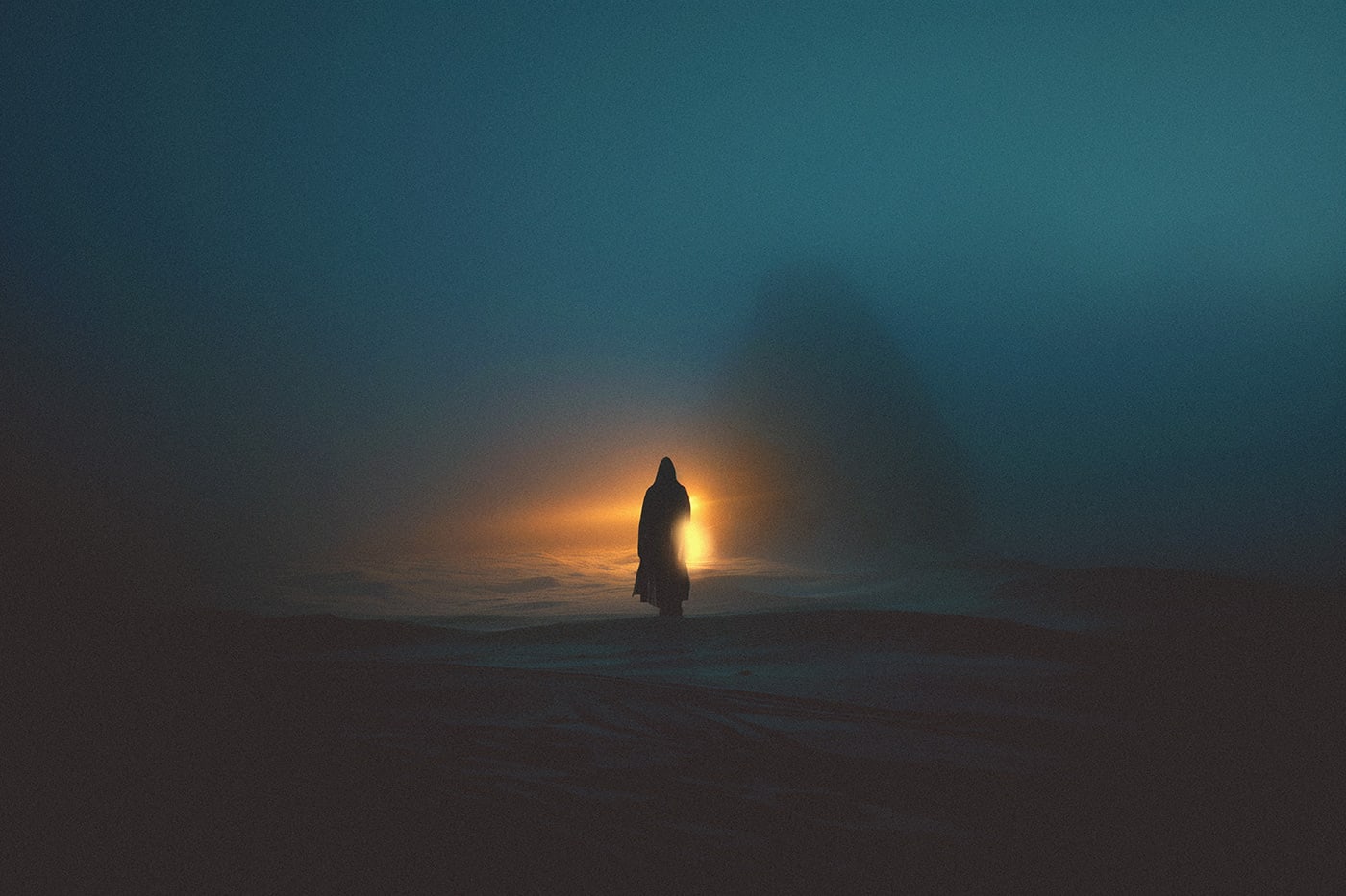 A mysterious hooded person wading through the thick fog in an empty snow landscape, approaching a mysterious warm light in the darkness. | Wall Art